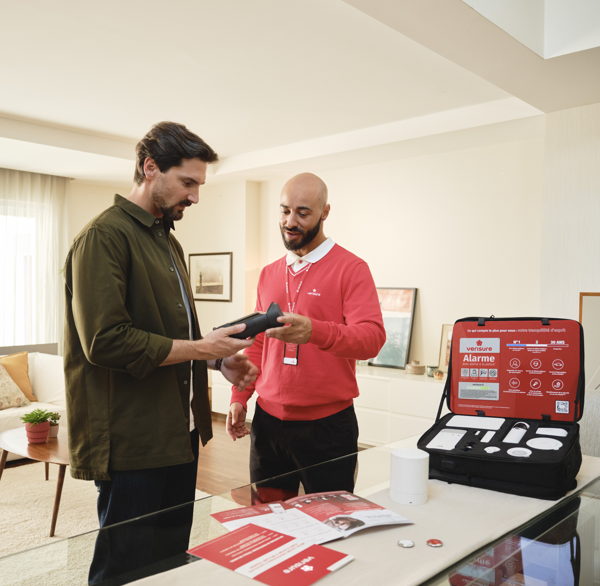 Verisure employee explaining security system to customer at home.